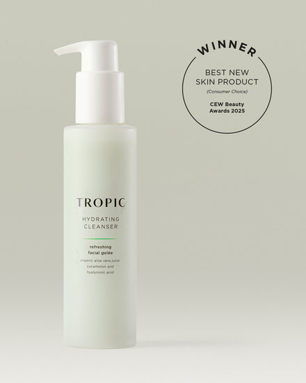 A bottle of Tropic Hydrating Cleanser stands against a soft neutral background. The sleek frosted pump bottle features minimalist black and green text reading “TROPIC Hydrating Cleanser – refreshing facial gelée with organic aloe vera juice, cucamelon and hyaluronic acid.” Above the product, a circular badge reads “WINNER – Best New Skin Product (Consumer Choice), CEW Beauty Awards 2025.”